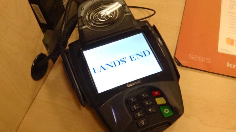 A card payment terminal at a shop counter