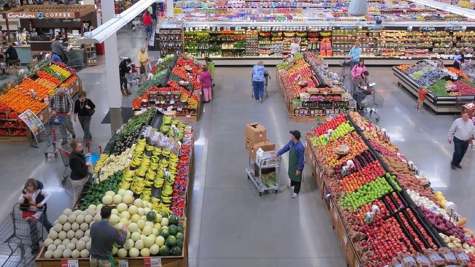 Shoppers in a large supermarket seen from above