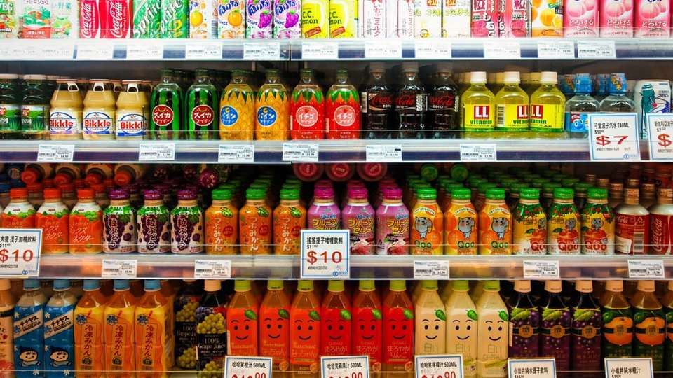 Supermarket shelves of drinks with price tags